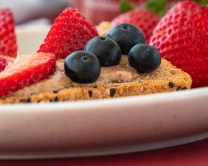 Bread with hazelnut butter and strawberries and blueberries