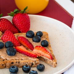 Bread with hazelnut butter and strawberries and blueberries