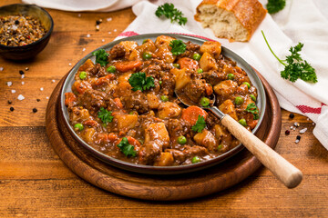 Beef Curry Stew with Potatoes and Carrots on Wooden Background. Selective focus.