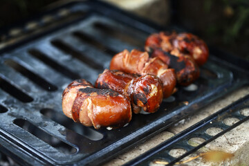Appetizing fried sausages on the grill.