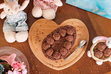 brazilian easter egg with a creamy spoon filled with Belgian chocolate brigadeiro flavor top view