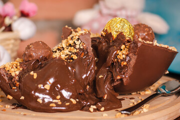 brazilian easter egg with creamy spoon stuffed chocolate bonbon flavor on board close up