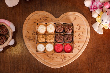 box of brazilian gourmet brigadeiros on heart board top view