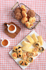 Assorted One Bites Mini Bread or Popular as Roti Unyil Venus on White Plate, White Background. Served for Accompanied Tea. Copy Space for Text