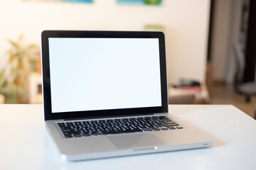laptop on white table