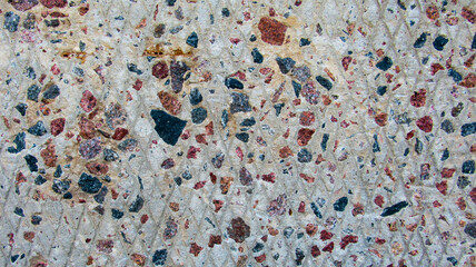 Background of a cement wall with stones in it
