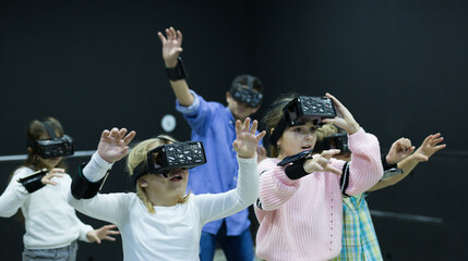Emotional tween kids having fun with vr headset goggles. Generation Alpha and new technology