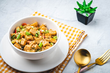 Sizzling Tofu- is deep-fried tofu sautéed in garlic, onion, pepper with cream sauce.