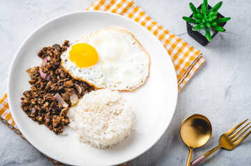 SisigSilog- is a typical Filipino Breakfast meal, consisting usually of sisig (a dish made from parts of a pig's face and belly, and chicken liver) , fried egg and fried rice