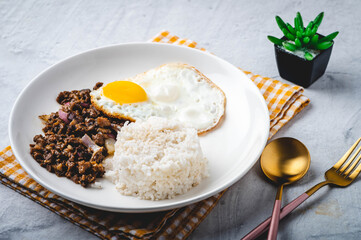 SisigSilog- is a typical Filipino Breakfast meal, consisting usually of sisig (a dish made from parts of a pig's face and belly, and chicken liver) , fried egg and fried rice