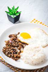 SisigSilog- is a typical Filipino Breakfast meal, consisting usually of sisig (a dish made from parts of a pig's face and belly, and chicken liver) , fried egg and fried rice