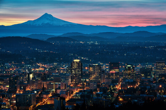 A colorful cityscape sunrise with Mt Hood and the city lights of Portland, Oregon