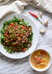 The plate of chili fried beef and a bowl of soup