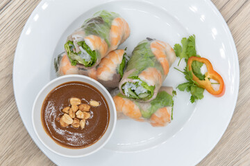 Overhead view of hearty plate of shrimp spring rolls loaded and sliced for a complete appetizer