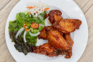 Overhead view of hearty plate of glazed chicken wings cooked to perfection for a complete meal