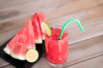 Sliced watermelon and a glass of watermelon juice