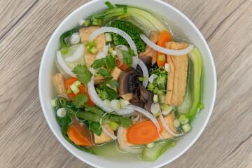 Overhead view of hearty bowl of Tofu Pho for the vegetarian appetite served in a hearty bowl