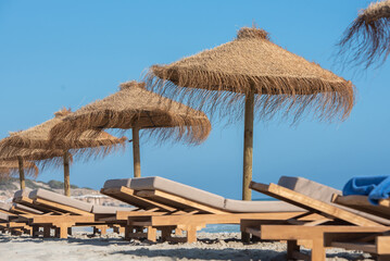 Deck chairs and straw umbrellas on the wonderful island of Formentera in Spain