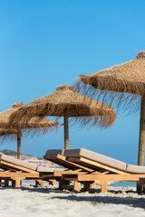 Deck chairs and straw umbrellas on the wonderful island of Formentera in Spain