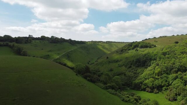 Devils Dyke, South Downs National Park, Sussex England. 4k Drone footage featuring paragliders and Poynings village at the foot of the downs