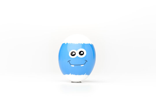 Blue festive easter egg with emoticon on white background