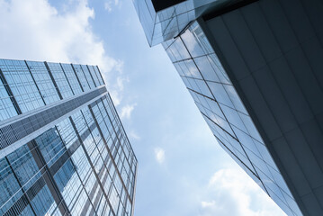 Fototapeta premium Chengdu cityscape low angle view of modern office building with clouds blue sky 