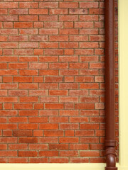 old brick wall with brown pipe