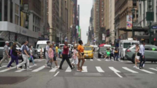 Anonymous crowd of people walking crossing street wearing masks slow motion summer 2021