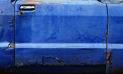 old blue door of car with crack texture