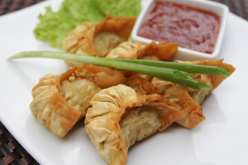 Traditional Chinese snack fried dumplings served with sweet chili sauce