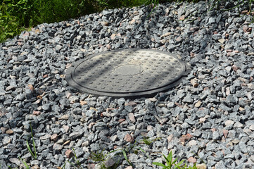 A close-up of a plastic septic tank manhole cover, manhole lid that covers a sewage tank with...