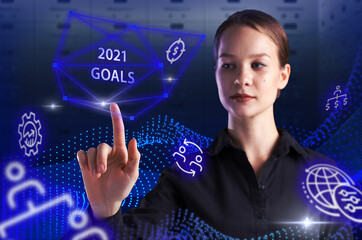 Business, Technology, Internet and network concept. Young businessman working on a virtual screen of the future and sees the inscription: 2021 goals