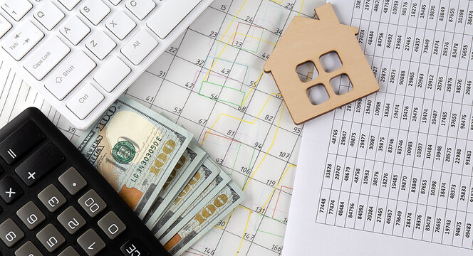 Paper business graphs with model of house,architectural plan, calculator and key,business