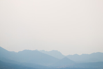 Mountains silhouette in the morning haze, copy space, Greece.