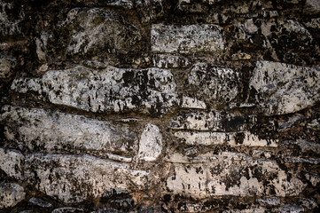 Texture of a stone wall. Old castle stone wall texture background. Stone wall as a background or texture. An example of masonry as a cladding of external walls.