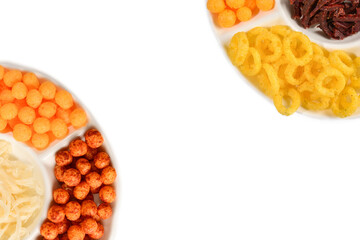 Mix of snacks on a white plate isolated on white.