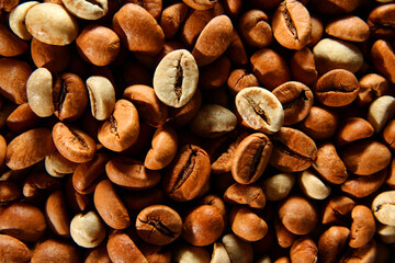 Mixture of raw and roasted coffee beans texture