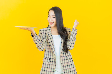 Portrait beautiful young asian woman smile with empty plate dish