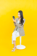 Portrait beautiful young asian woman smile with smart mobile phone