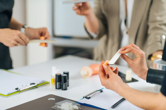 Manicure Practice with Artificial Acrylic Fingernails, using Mannequin Training Hand in Cosmetology Center