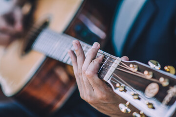 Close up hand playing guitar