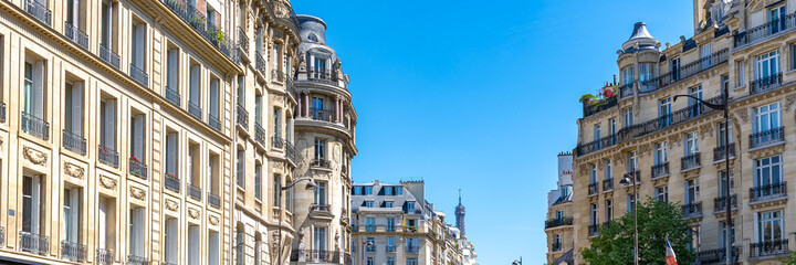Fototapeta na wymiar Paris, beautiful Haussmann facades in a luxury area of the capital, with the Eiffel Tower in background 