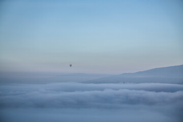 Obraz na płótnie Canvas minimal balloon above the mountain and fog