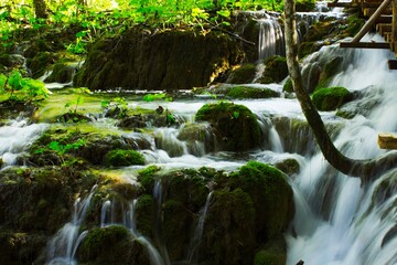 Smooth river flowing and small waterfalls on Plitvice Lakes