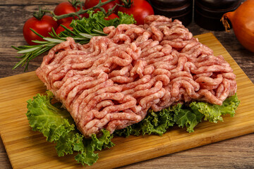 Raw pork minced meat over board