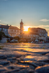 Krk, the largest town on the Krk island, Kvarner bay, Croatia. Scenic view of the harbor, embankment and Krk cathedral at sunrise, outdoor travel background