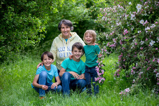 Grandmother and grandchildren, playing together in the park, spring
