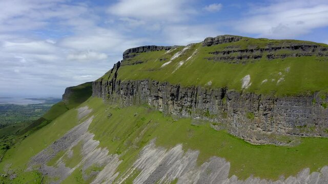 Kings Mountain, Sligo, Ireland, June 2021. Drone slowly ascends the southern face flying over the peak revealing a breathtaking view of Sligo Bay with Strandhill and Knocknarea in the distance.