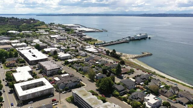 Cinematic 4K drone dolly clip of the downtown Edmonds commercial area, Kingston ferry terminal waterfront marina, near Seattle in Western Washington, Pacific Northwest, in Snohomish County