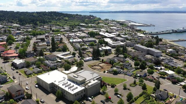 Cinematic 4K drone dolly shot of the downtown Edmonds commercial area, Kingston ferry terminal waterfront marina, Puget Sound near Seattle in Western Washington, Pacific Northwest, in Snohomish County